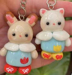 two small plastic animals are sitting on a person's hand and one is holding the other