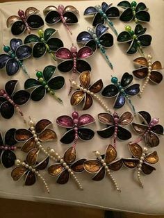 many different colored dragonflys with pearls on them