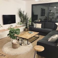 a living room filled with furniture and a flat screen tv mounted to the side of a wall