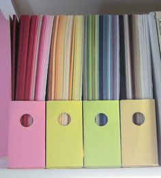 several different colored file folders on a shelf