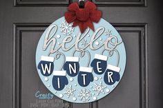 a door hanger that says hello winter with stockings and snowflakes on it