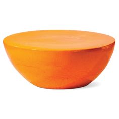 an orange bowl sitting on top of a white table