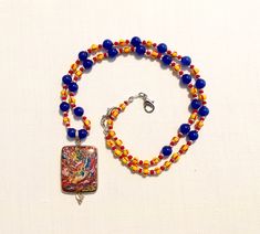 "Multicolor rainbow Calsilica beaded 21\" necklace, with Chinese blue sapphire and striped seed beads.  Comes with gift pouch." Rectangular Beaded Necklace With Large Beads For Gifts, Colorful Beads Lapis Lazuli Necklace Gift, Rectangular Gemstone Beaded Necklaces For Gifts, Rectangular Gemstone Beaded Necklace For Gift, Colorful Lapis Lazuli Beaded Necklaces As Gifts, Lapis Lazuli Beaded Necklaces With Large Beads As Gift, Lapis Lazuli Beaded Necklace With Large Beads For Gift, Colorful Czech Glass Beaded Necklaces For Gifts, Large Rainbow Beads For Gift