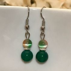 Shop sarahgath's closet or find the perfect look from millions of stylists. Fast shipping and buyer protection. Handmade earrings Top bead is orange white green blended and the bottom bead is jade with a silver hook earring Set #7 Jade Beaded Earrings For Jewelry Making, Adjustable Jade Beaded Earrings As A Gift, Elegant Green Hypoallergenic Beaded Earrings, Green Round Beaded Earrings For Gift, Green Round Beaded Earrings As Gift, Round Green Beaded Earrings As Gift, Handmade Green Crystal Earrings, Green Sterling Silver Beaded Earrings With Round Beads, Handmade Green Crystal Sterling Silver Earrings