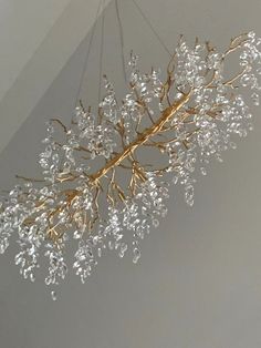 a chandelier hanging from the ceiling in a room with white walls and flooring