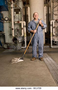 a man is cleaning the floor with a broom