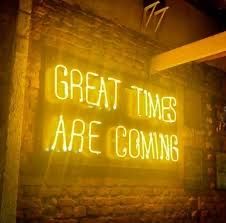 a neon sign that says great times are coming