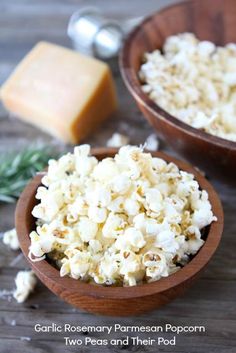 garlic rosemary parmesan popcorn two peas and their pods are in wooden bowls