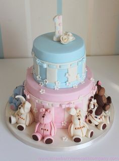 a blue and pink cake with animals on it