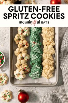 gluten - free spritz cookies in a tray with christmas decorations