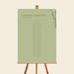 an easel with a wedding seating chart on it and flowers in the center is shown