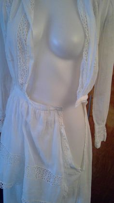 "Edwardian lingerie dress. Sheer white fabric with gorgeous lace inserts and trim. Wide sailor style collar . Bodice opens to a deep v. Front and back apron like panels. This is in such great condition for a dress that's 100 years old. No stains or holes. I made one repair to a break in the insert lace in one of the lower tiers of the skirt. All the hook and eye closures are missing so you will need to add them. Shown on my mannequin 34 1/2\" bust, 26\" waist. 36\" hips My measurement taken flat Long Lace Dress For Daywear, Feminine Fitted Victorian Daywear Dress, Fitted Feminine Victorian Dress For Daywear, Feminine Fitted Victorian Dress For Daywear, Vintage Dress With Lace Trim For Daywear, Fitted Vintage Dress With Lace Patchwork For Daywear, Vintage White Victorian Dress With Lace Trim For Daywear, Fitted Vintage Dress With Lace Collar For Daywear, Open Front White Dress For Daywear