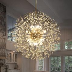 a large chandelier hanging from the ceiling in a room with white walls and windows