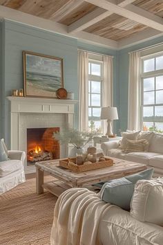 a living room filled with furniture and a fire place in front of two windows on either side of the fireplace