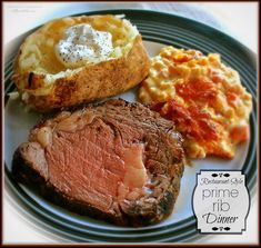 a white plate topped with meat, macaroni and cheese next to a baked potato