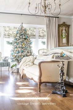 a bedroom decorated for christmas with a tree in the corner