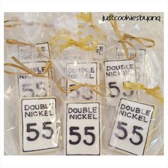 three tags with the numbers 55 and 55 on them are wrapped in cellophane