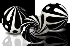 three black and white balls on a reflective surface