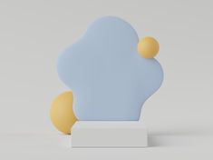 a blue and yellow sculpture sitting on top of a white block