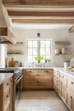 a kitchen filled with lots of wooden cabinets and counter top space next to a window