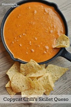 a bowl of chili and tortilla chips on a wooden table with the title copycat chili's skillet quesadilla