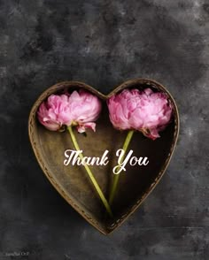 two pink flowers in a heart shaped box with the words thank you