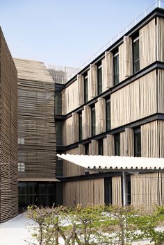 the building is made out of wood and has many windows on each side, along with several balconies