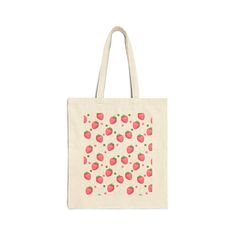 Featuring a charming pink strawberry design with whimsical bubble accents, this tote is perfect for adding a touch of fun to your everyday errands. Grab yours now and make a statement wherever you go! This 100% cotton bag comes in one size – 15" x 16"– perfect for everyday wear. The bag features 20" handles (made from the same canvas). .: 100% cotton canvas.: Available in natural and black colors.: Heavy fabric (12 oz/yd² (406.9 g/m²)).: Sewn-in label 15" x 16" Width, in 15.00 Length, in 16.00 H Tout Rose, Strawberry Design, Best Tote Bags, Bottle Garden, Pink Strawberry, 4th Of July Outfits, Blue Daisy, Red Strawberry, Coral Peach