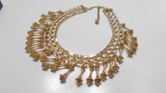 "Vintage gold tone dangling choker necklace. 15\" long including the chain fastener. Band is 3/4\" tall, consisting of smooth & brushed gold tone metal links. Twenty-seven (27) 1\" dangles are all present and intact. Absolutely gorgeous & classic! Unsigned." Gold Dangle Chain Choker, Gold Metal Dangle Choker, Unicorn Pendant, Pearl Pendant Necklace, Choker Necklaces, Pearl Pendant, Gold Tone Metal, Vintage Gold, Faux Pearl