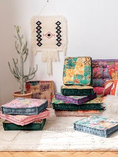 a room filled with lots of different colored cushions and pillows on top of each other