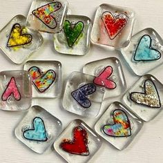 nine glass hearts with different colors and shapes