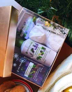 an assortment of bath products displayed in front of a christmas ornament and tree