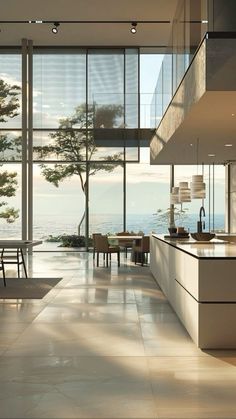 an open kitchen and dining area with large windows overlooking the ocean is pictured in this image