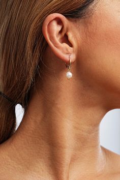 Embrace modern elegance with these dainty hoop earrings adorned with lustrous pearls, effortlessly transitioning from day to night. Pearl Huggie Hoop Earrings, Pearl Drop Dangle Huggie Earrings, Elegant Pearl Hoop Earrings With Ear Wire, Pearl Hoop Huggie Earrings, Dainty Pearl Teardrop Hoop Earrings, Elegant Everyday Huggie Earrings With Pearl Charm, Dainty Hoop Earrings With Pearl Chain, Classic Dangle Hoop Earrings With Pearl Charm, Elegant Pearl Huggie Dangle Earrings