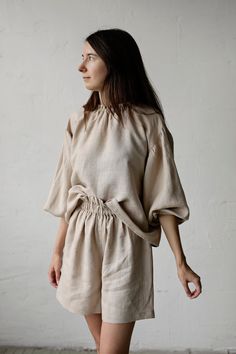 "Tokyo tunic is made from 100% soft and washed linen. Details: - Colour: Sand - Composition: 100% Oeko-Tex certified linen - Ruffle neckline - Dropped shoulders - Long sleeves - Loose fit - Medium weight linen - Linen care: machine wash gentle; tumble dry low, ironing optional - The price is for one tunic, other pictured items are not included The model is 170 cm/5'7\" and wears a size S." Beige Relaxed Fit Tunic Blouse, Relaxed Fit Beige Ramie Tops, Relaxed Fit Ramie Blouse For Daywear, Beige Relaxed Fit Ramie Top, Spring Linen Loungewear Blouse, Relaxed Fit Ramie Tops For Daywear, Relaxed Fit Linen Blouse, Beige Linen Tunic With Relaxed Fit, Flax Cotton Blouse With Relaxed Fit