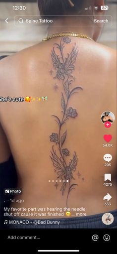 the back of a woman's neck with flowers on it and an arrow in the middle