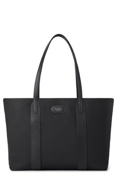 A spacious nylon tote is roomy enough for a tablet, a pair of shoes and all the essentials you need to take along. The classic style closes with the label's signature Portsman's patch and features a luxurious suede lining. Magnetic closure Top carry handles Internal removable pocket Suede lining 70% polyamide, 30% leather Imported Designer Handbags Classic Waterproof Everyday Bags, Classic Everyday Waterproof Bags, Classic Waterproof Leather Bag, Classic Leather Waterproof Bag, Waterproof Black Leather Bags, Mulberry Bag Bayswater, Lotion Brands, Mulberry Bayswater, Mulberry Bag