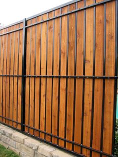 a wooden fence with metal bars on it