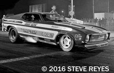 a black and white photo of a drag car