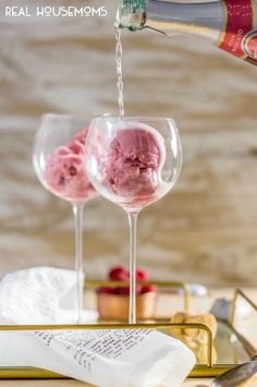 two wine glasses with ice cream being poured into them