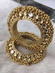 *This is Gold Finish Kundan Bangle Pair.Its Perfect for Wedding Occasion and is Unique and Ethnic Traditional Bangle to gift and also Bridal wear to match with Wedding Outfits. * Its made from Silver and Copper mix material and is 100% Handmade. * Its available in Various Sizes like 2,2.2,2.4,2.6 Etc.Its a combination of white kundan as shown in picture. *Its openable and Screwed Bangle Pair. *All Kundan stones set with silver foils handsetting method and long last guarantee of its workmanship.M Adjustable Kundan Jewelry For Weddings, Adjustable Chandbali Jewelry For Wedding, Handmade Bangle For Marriage And Festivals, Handmade Bangle For Wedding And Festivals, Gold Hand Set Bridal Earrings For Wedding, Gold Toe Ring Jewelry For Diwali, Gold Hand-set Bridal Earrings For Wedding, Traditional Gold Chandbali Bridal Accessories, Bollywood Style Bangle For Diwali Wedding