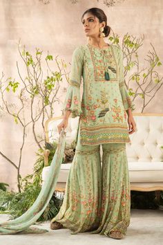 Mint green kurta with all-over floral print, delicate embroidery, notched neckline and flared sleeves. Comes with sharara and dupatta.
Component: 3
Printed, Embroidered
Neckline: Round
Sleeve Length: Full
Fabric: Georgette
Color: Green
Straight kurta
Notched round neckline
Printed sharara and dupatta - Aza Fashions Printed Sharara, Mustard Skirt, Mehendi Outfit, Sharara Designs, Mehndi Outfits, Mehendi Outfits, Girls Attire, Desi Girl, Sharara Set