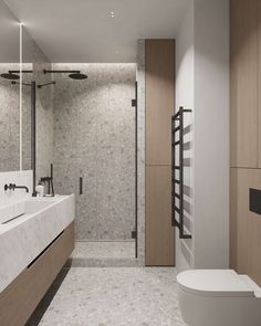 a bathroom with a toilet, sink and shower stall in it's center area