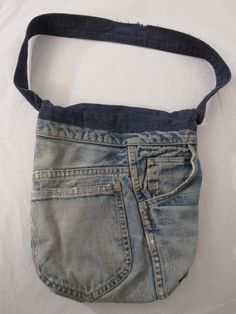 "Vintage 1960s Levis big E denim purse. Made out of Levis denim pants. Unique purse. Has blue corduroy lining and the number 1 in studs on the flap. Label reads: CARPETBAGS OF AMERICA. Bag measures 9.5\" wide and 10.5\" tall. In very good condition. Might be missing two studs." Vintage Denim Bag With Pockets, Vintage Denim Blue Shoulder Bag For Everyday, Vintage Denim Blue Everyday Shoulder Bag, Vintage Denim Bags For Daily Use, Vintage Denim Blue Shoulder Bag, Vintage Blue Denim Shoulder Bag, Vintage Everyday Denim Bag, Vintage Style Everyday Denim Bag, Everyday Vintage Denim Bag