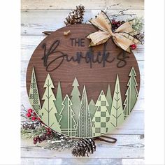 a wooden sign that says the burners with pine cones and evergreens around it