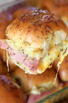 a ham and cheese slider being held up