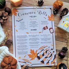 a table with autumn decorations, candles and an open menu for cinnamon rolls on it