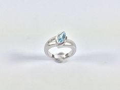 "Hi everyone, just wanted to let you know we are open and shipping daily. Beautifully crafted \"one of a kind\" contemporary Sterling Silver ring with genuine London Blue Topaz. The silver ring is finished with Rhodium so it will not tarnish. The gemstone used in this ring has been hand picked on a recent trip to Bangkok and is of a quality usually reserved for fine jewelry so you will almost never find such nice stones set in sterling silver! Weight 7.3 Grams This fine jewelry quality ring is p Modern White Gold Birthstone Ring With Accent Stones, Modern Sterling Silver Birthstone Ring For Formal Events, Modern Sterling Silver Birthstone Ring For Formal Occasions, Modern Sterling Silver Topaz Ring For Formal Occasions, Modern Silver Hallmarked Topaz Ring, Modern Blue Topaz Ring, Round Shape, Modern White Gold Topaz Ring As Gift, Modern Blue Topaz Round Ring, Modern Hallmarked Silver Topaz Ring