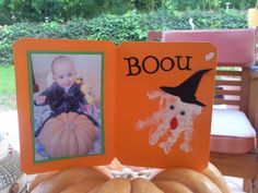 an orange book with a picture of a baby and a dog on it sitting on top of a pumpkin