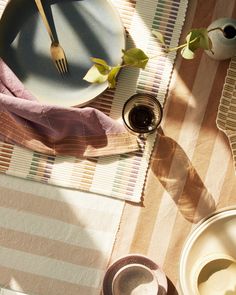 a table topped with plates and utensils on top of a checkered cloth